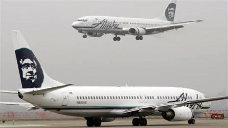 FILE - In this Jan. 17, 2009 file photo, an Alaska Airlines plane comes in for a landing as another taxis for takeoff at Seattle-Tacoma International Airport in Seattle. Alaska Airlines and its Horizon Air affiliate are canceling dozens of flights because their computer system failed. Company spokesman Paul McElroy says the two airlines canceled 60 flights by late Saturday morning, March 26, 2011, six hours after the outage started. (AP Photo/Ted S. Warren, File)