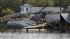A shrimp boat is bashed against the dock of Daniel's Seafood at the shoreline of the Pamilco River near Aurora, N.C., Sunday, Aug. 28, 2011 after Hurricane Irene hit the North Carolina coast.