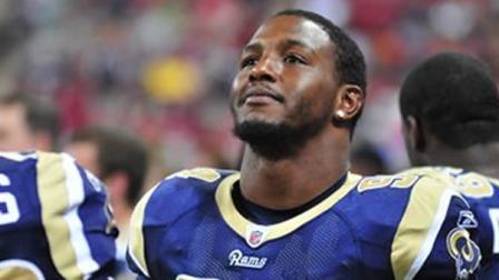 St. Louis Rams defensive end Robert Quinn stands on the sideline during the first quarter of an NFL football game against the Tennessee Titans Saturday, Aug. 20, 2011, in St. Louis.