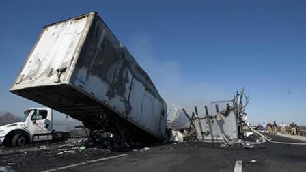 Debris and wreckage lie along the highway after a multi-vehicle accident that killed at least nine people, on Interstate 75 near Gainesville, Fla., Sunday, Jan. 29, 2012. (AP Photo/Phil Sandlin)