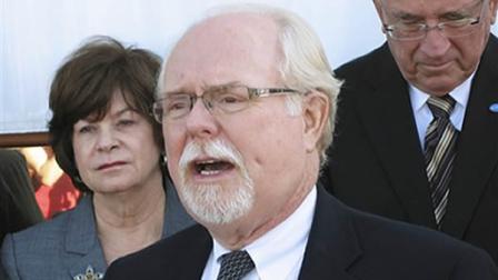 FILE - This Feb. 16, 2011, file photo shows Ron Barber, one of the people wounded in the attack on Arizona congresswoman Gabrielle Giffords, backed by County Attorney Barbara LaWall and Tucson Mayor Bob Walkup, in Tucson, Ariz. Barber, a top aide to Giffords, who was shot in the leg and face in the Tucson rampage that also left the congresswoman severely wounded, announced Thursday that he will seek to replace her in a special election.