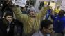 Ray Schwarz, 28, celebrates after waiting 24-hours to enter Best Buy Friday, Nov. 23, 2012, in Mayfield Heights, Ohio. The store opened at 12 a.m. on Friday. Schwarz was buying three televisions, a sound system and video games.
