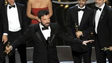 Director/producer Ben Affleck, center, accepts the award for best picture for Argo, as the cast and crew look on during the Oscars at the Dolby Theatre on Sunday Feb. 24, 2013, in Los Angeles. (Photo by Chris Pizzello/Invision/AP)