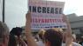 A protestor holds up a sign at a recent demonstration in Raleigh.