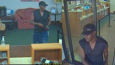 A surveillance photo from First Citizens Bank shows the man approaching the teller with a note demanding money around 1:30 p.m.