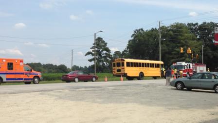 Emergency workers at the scene of a an accident involving a school bus at Buffalo Road and Covered Bridge Road northeast of Clayton in Johnston County.