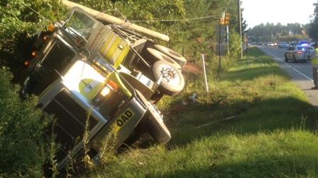The huge vehicle went down an embankment and smashed through the supports for the intersections traffic light system.