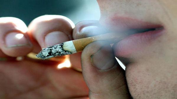 Photo of a man smoking a cigarette