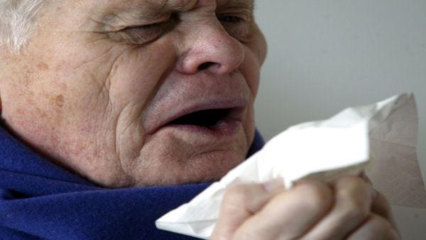 Photo of a man about to sneeze