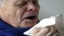 Photo of a man about to sneeze
