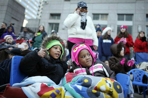 Four year-old twins Kaiden Leach, left, and...