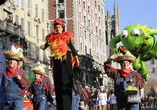 Costumed characters and a marching band precede...