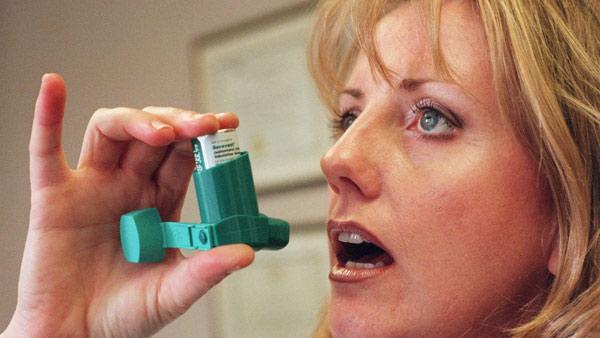 Woman using inhaler