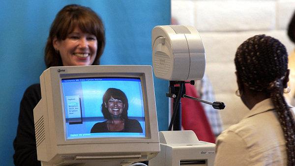 Woman stands to take her drivers licenses photo