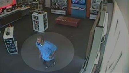 Police say the suspect acted as if he were a customer then made out with several iPhones.