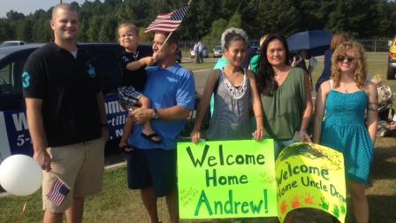 Family members await the arrival of their loved ones Sunday as nearly 100 soliders return home from a year overseas.