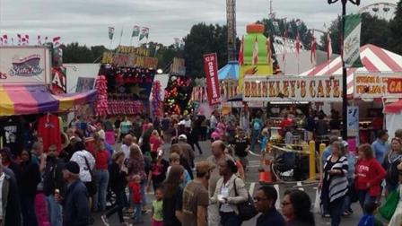 Fairgoers enjoy a Friday afternoon full of food and rides.