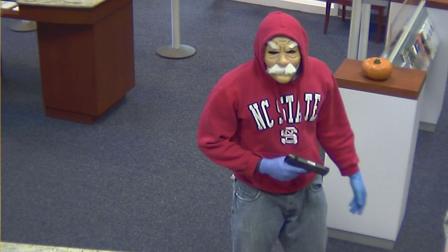 Two white males wearing Halloween masks robbed a bank on Governors Drive armed with handguns, according to officials.