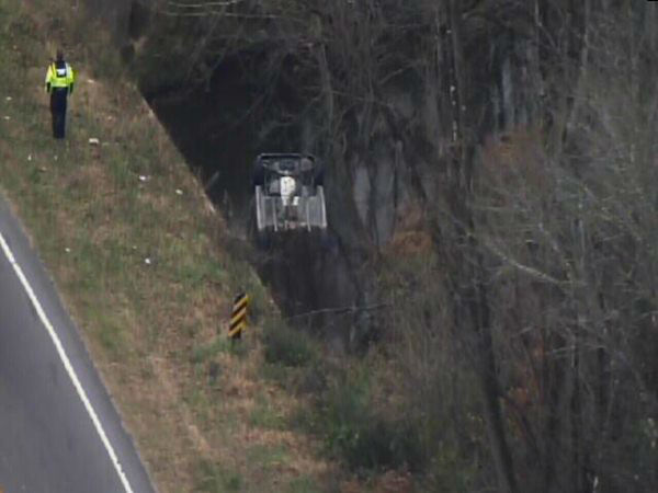 Emergency workers pulled an upside down car out...