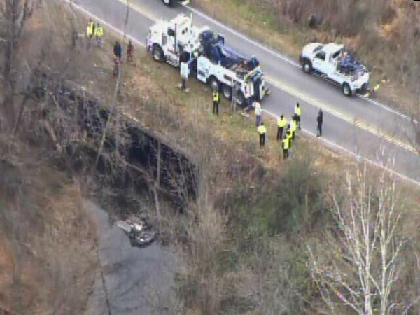 Emergency workers pulled an upside down car out...