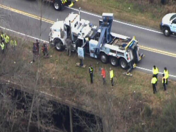 Emergency workers pulled an upside down car out...