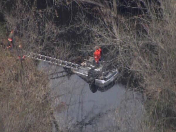 Emergency workers pulled an upside down car out...