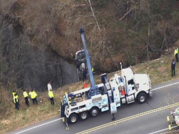 Emergency workers pulled an upside down car out...
