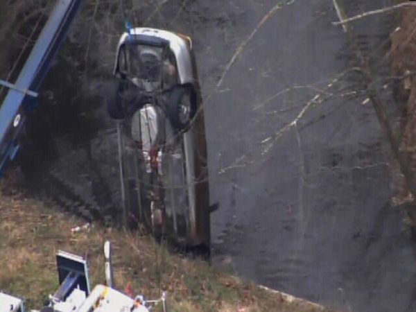 Emergency workers pulled an upside down car out...
