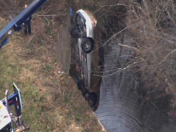 Emergency workers pulled an upside down car out...
