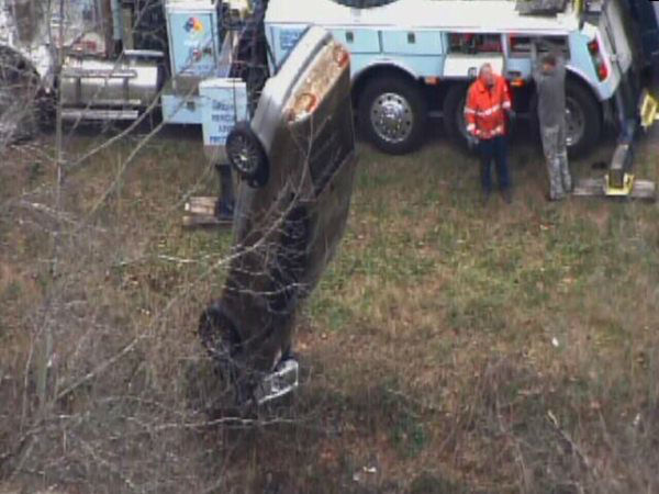 Emergency workers pulled an upside down car out...
