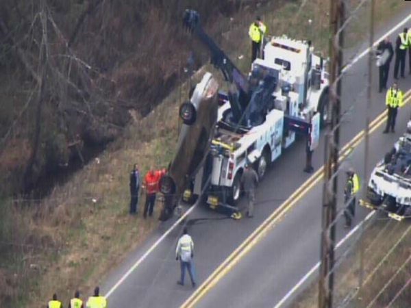 Emergency workers pulled an upside down car out...