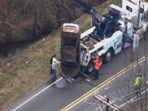 Emergency workers pulled an upside down car out...