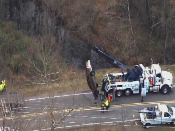 Emergency workers pulled an upside down car out...