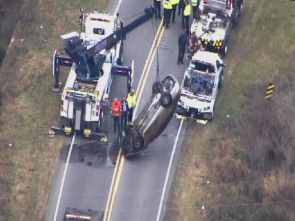 Emergency workers pulled an upside down car out...