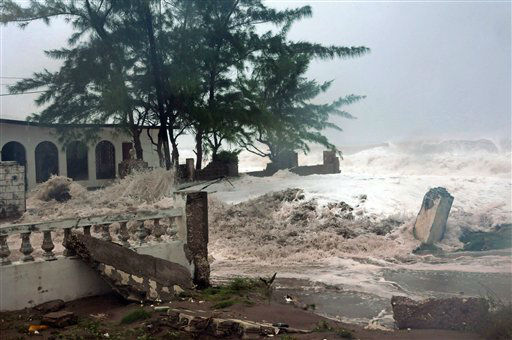 Waves, brought by Hurricane Sandy, crash on a...