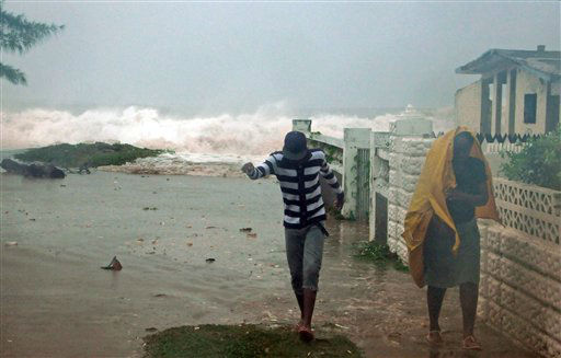 Residents evacuate their home as waves crash in...