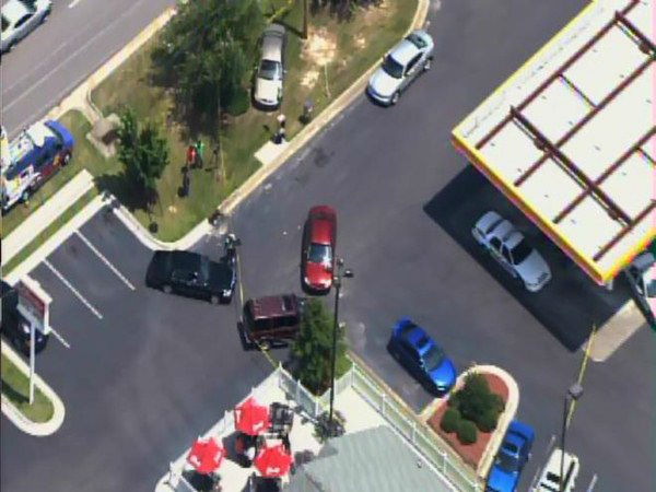 Officers investigate at a gas...