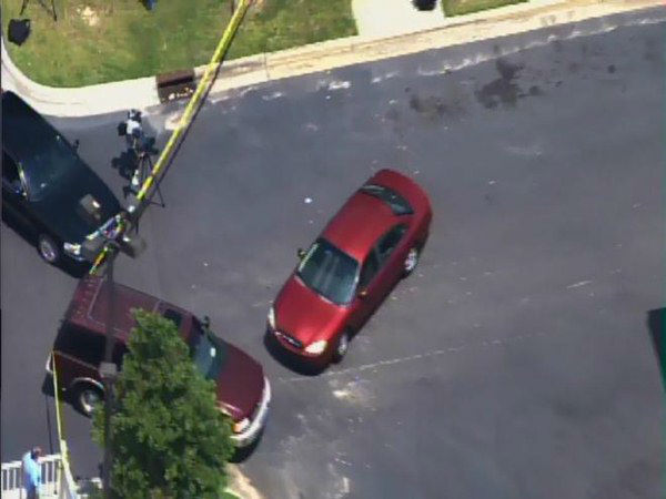Officers investigate at a gas...