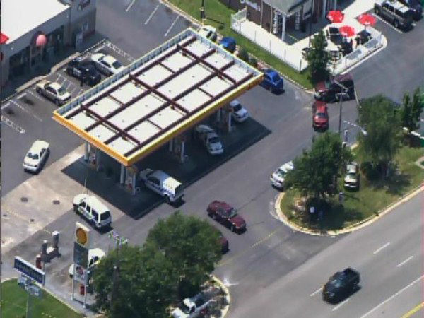 Officers investigate at a gas...