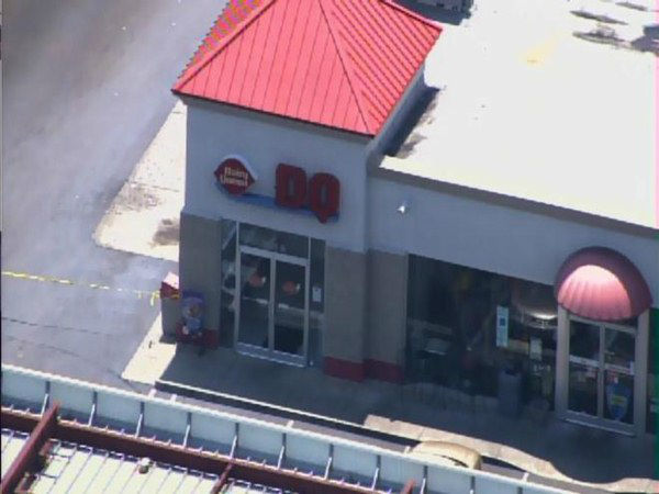 Officers investigate at a gas...