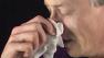 Man blowing nose