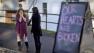 Shop owners Tamara Doherty, left, and Jackie Gaudet, right, meet outside their stores for the first time since being neighbors, just down the road from Sandy Hook Elementary School, Saturday, Dec. 15, 2012, in Newtown, Conn. The massacre of 26 children and adults at Sandy Hook Elementary school elicited horror and soul-searching around the world even as it raised more basic questions about why the gunman, 20-year-old Adam Lanza, would have been driven to such a crime and how he chose his victims. 