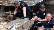 Moore police dig through the rubble of the Plaza Towers Elementary School following a tornado in Moore, Okla., Monday, May 20, 2013.
