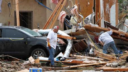 Joe Curry, left, and his friend search for his wifes purse in the damaged remains of his home in Moore, Okla., on Tuesday, May 21, 2013.