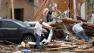 Joe Curry, left, and his friend search for his wifes purse in the damaged remains of his home in Moore, Okla., on Tuesday, May 21, 2013.