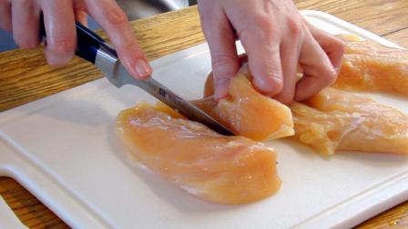 Raw chicken sliced on cutting board