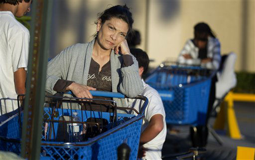 Dora Hurtado waits in line at a Pembroke Pines,...