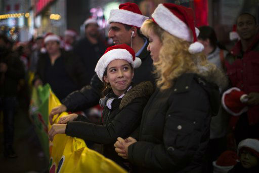 Shoppers wait in line for the 8 p.m. opening of...