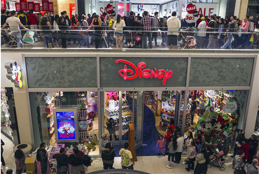 Consumers shop early morning hours Friday, Nov....