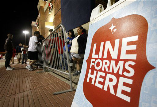 Shoppers line up outside a Best Buy department...